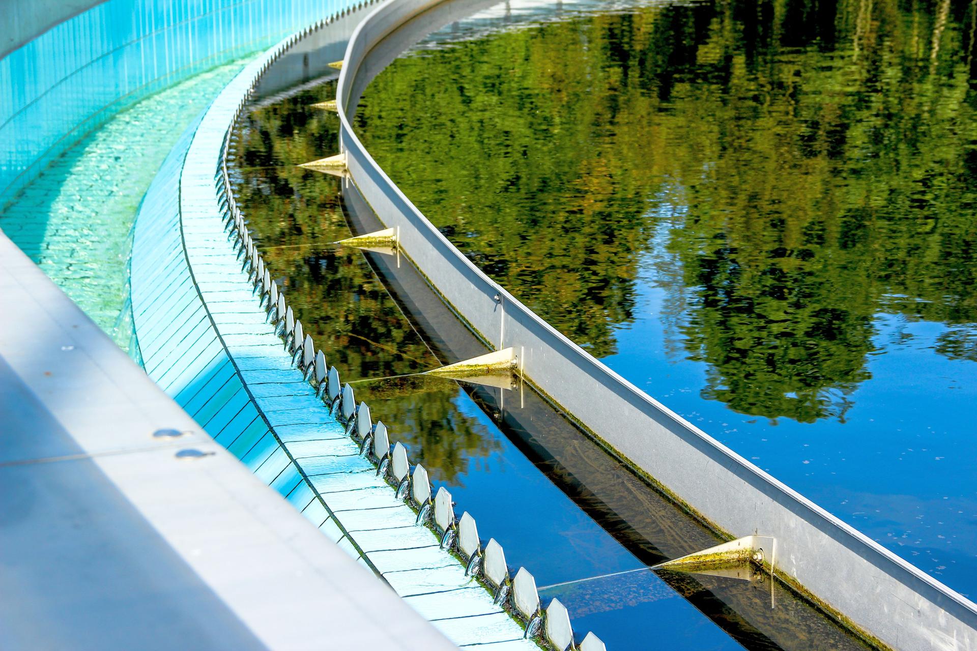 Sewage water plant with a reflection of trees in the water